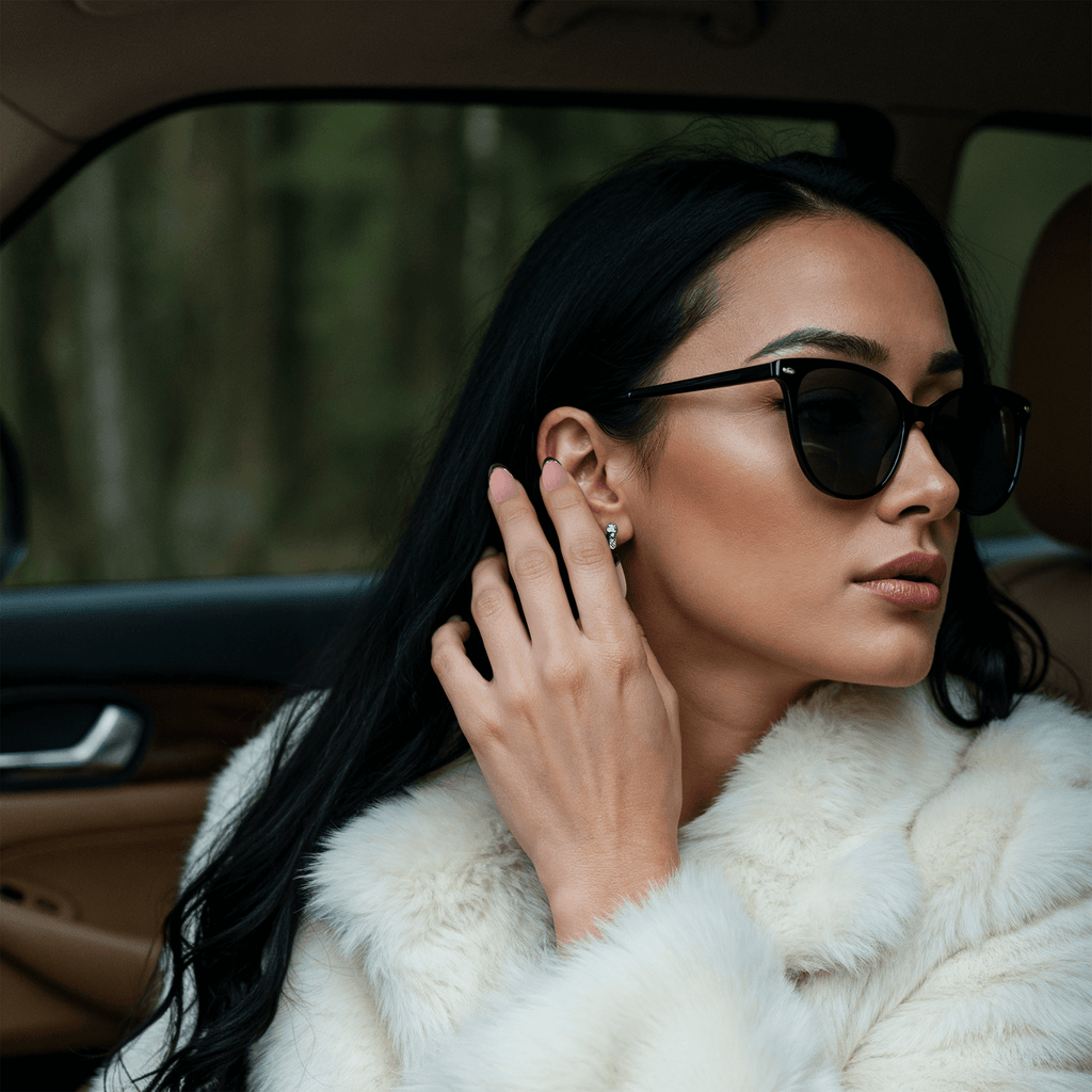 woman sitting in a car showing her nails